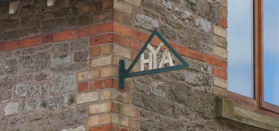A YHA sign on a brick building