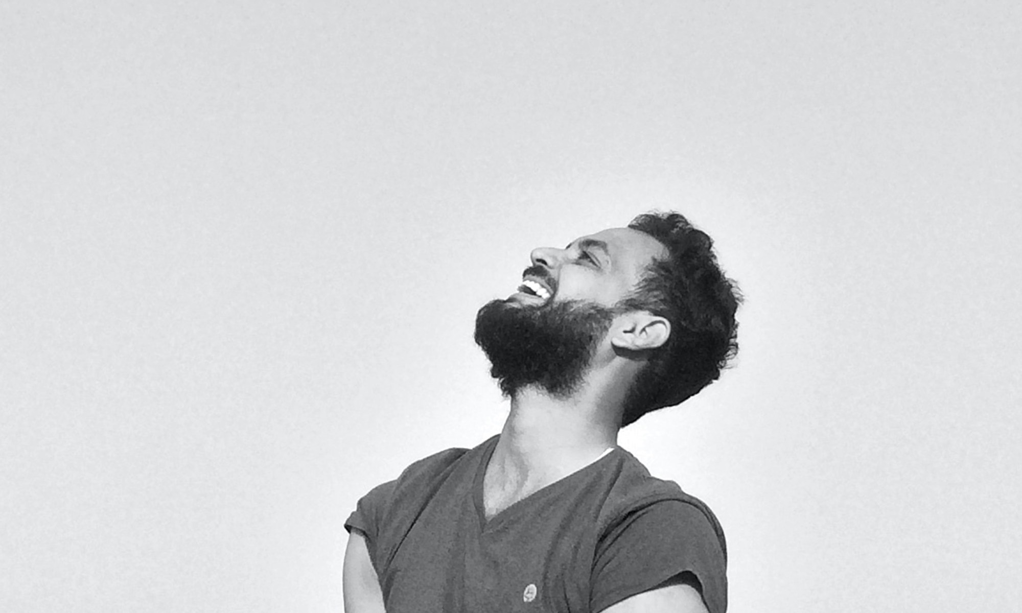 A person looking up to the sky and laughing.